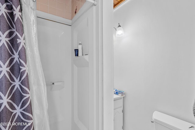 bathroom featuring vanity, toilet, and a shower with curtain