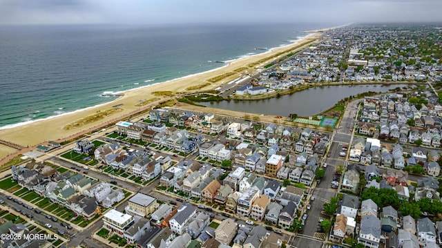 bird's eye view featuring a view of the beach, a water view, and a residential view