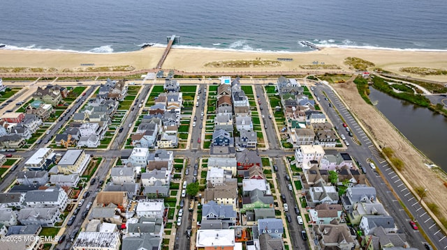 bird's eye view with a water view, a beach view, and a residential view