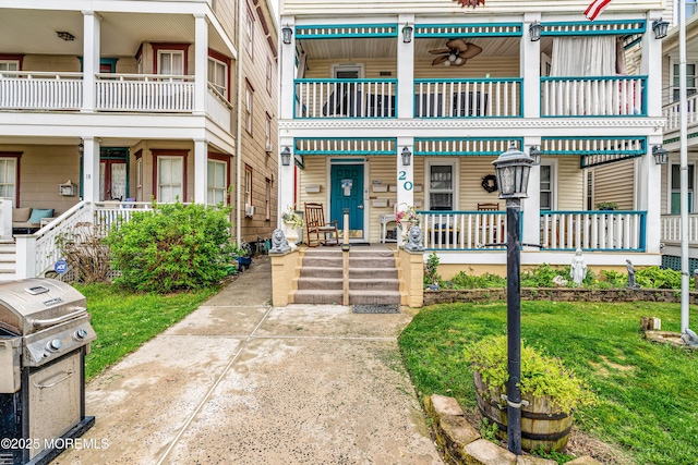 property entrance featuring covered porch and a yard