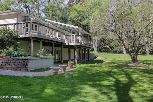 rear view of house with a deck and a lawn