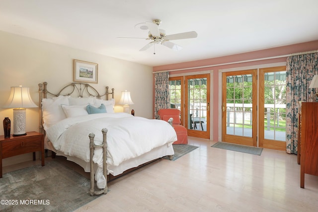 bedroom with access to outside, wood finished floors, and ceiling fan