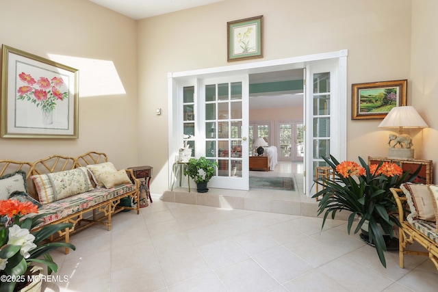 living area with tile patterned floors and french doors