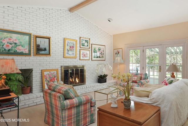 living area featuring wood finished floors, a fireplace, and vaulted ceiling with beams