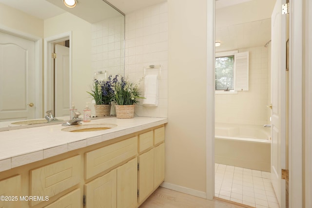 full bath featuring vanity and a tub