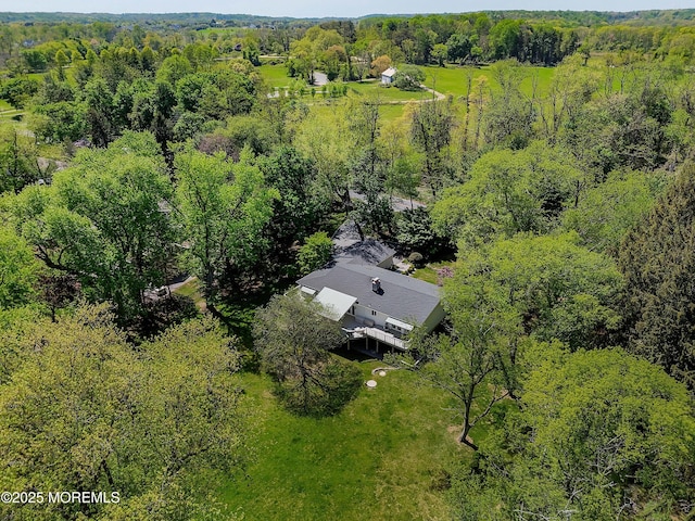 drone / aerial view featuring a forest view