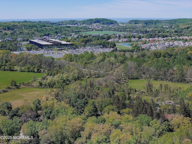 birds eye view of property featuring a view of trees