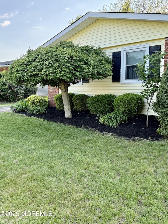 view of side of property with a yard