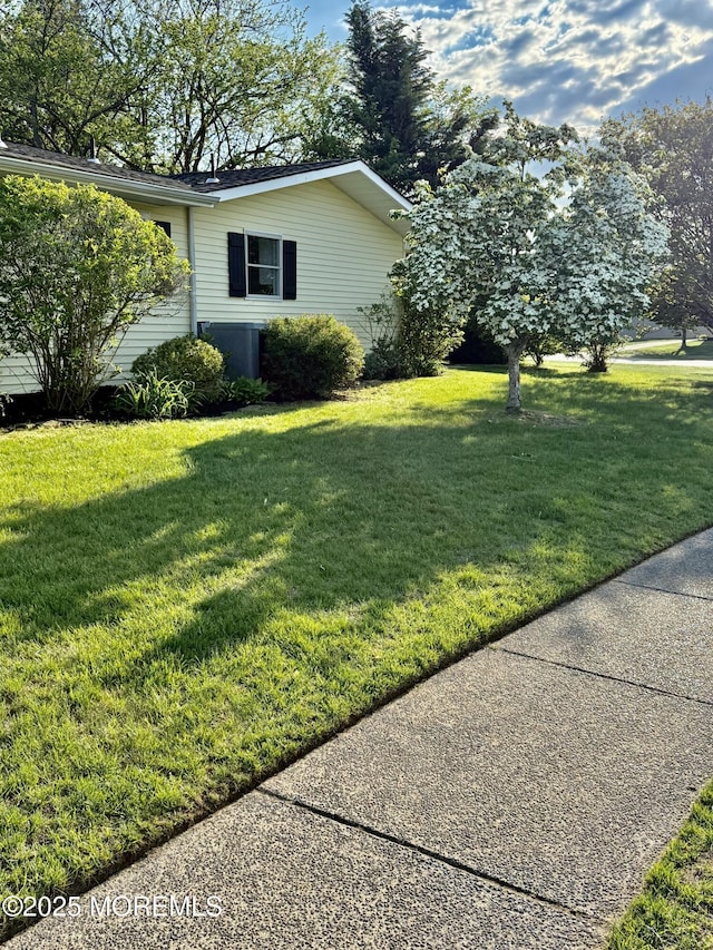 view of side of home with a lawn