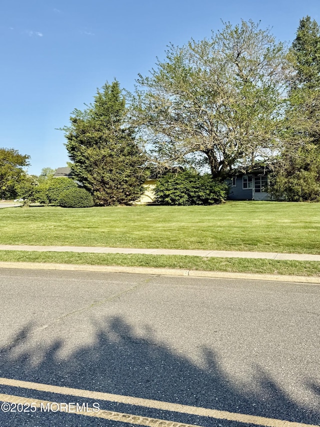 view of asphalt street with sidewalks