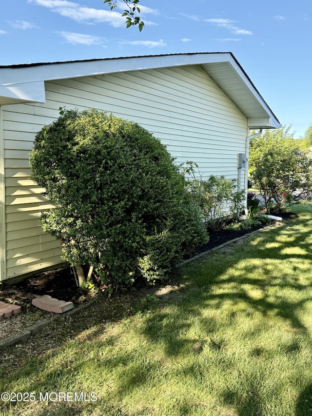 view of side of home featuring a yard