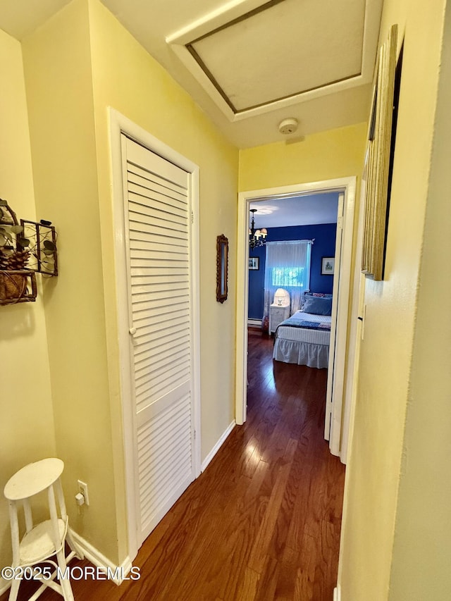 hall featuring dark wood finished floors and baseboards