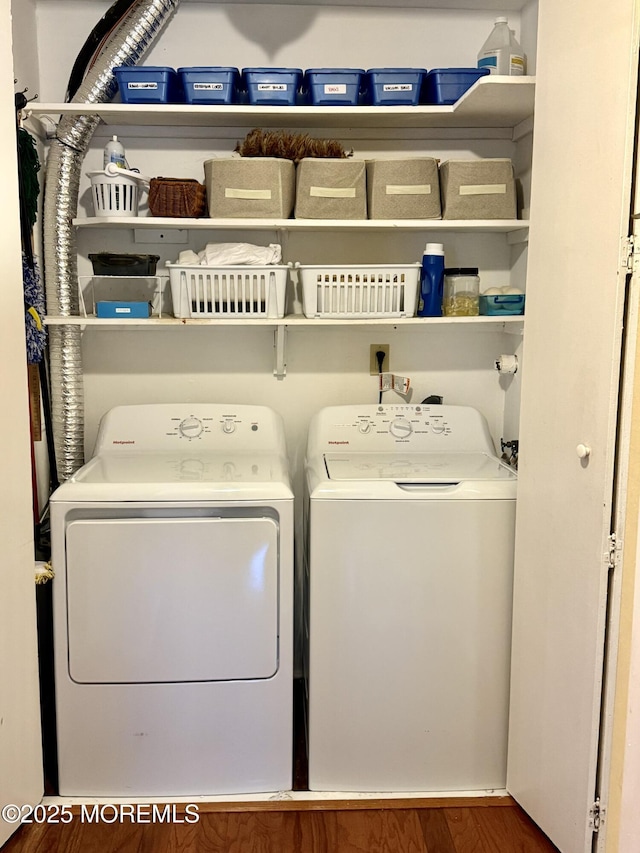laundry area with separate washer and dryer and wood finished floors