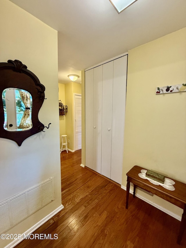 hall with wood finished floors and baseboards