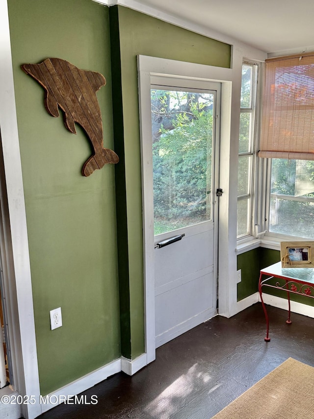 doorway with plenty of natural light and baseboards