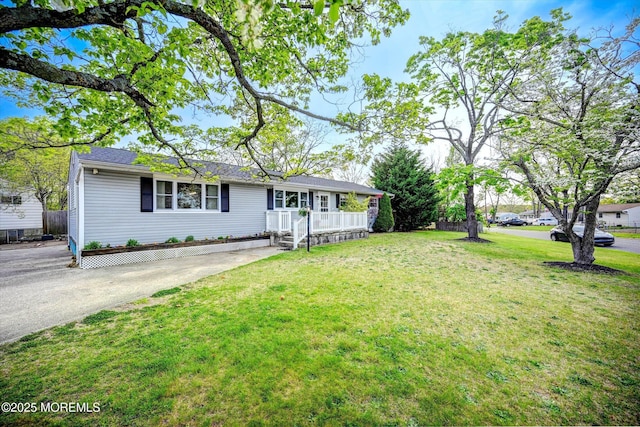 single story home featuring covered porch and a front yard