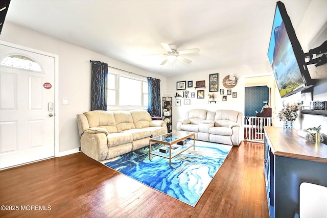 living room with ceiling fan and wood finished floors