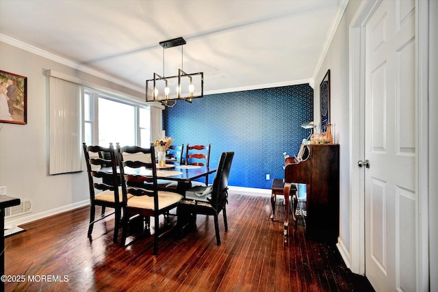 dining area featuring baseboards, a chandelier, ornamental molding, and hardwood / wood-style flooring