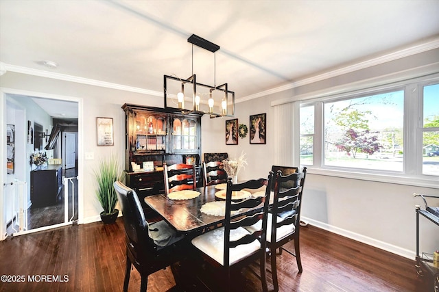 dining room featuring baseboards, crown molding, dark wood-type flooring, and a notable chandelier