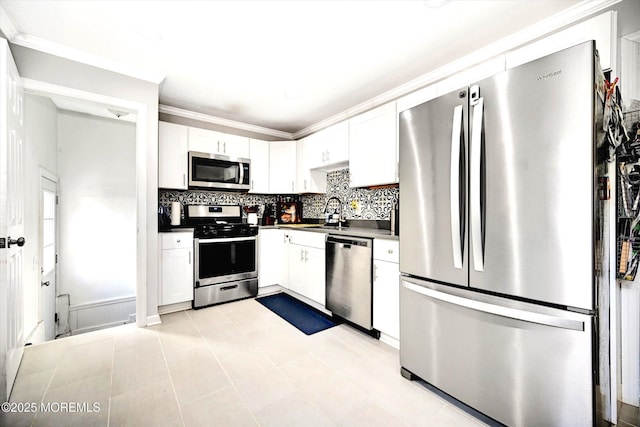 kitchen with stainless steel appliances, white cabinetry, and a sink