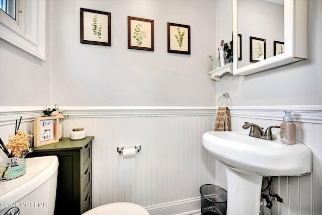 half bath with toilet and wainscoting