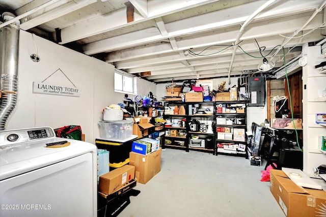 storage room featuring electric panel and washer / clothes dryer