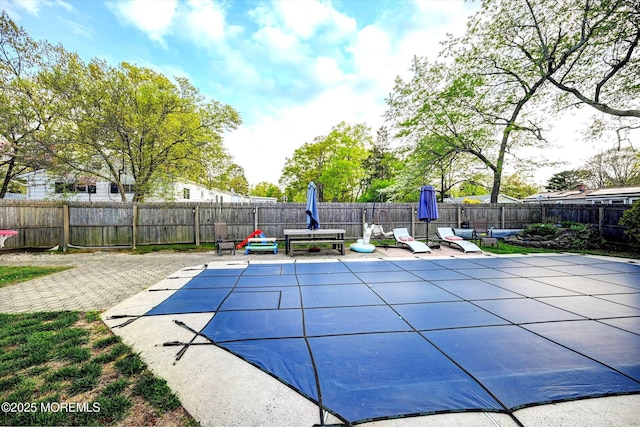 view of pool with a fenced backyard and a patio