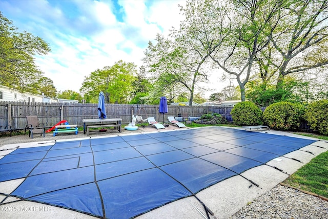 view of swimming pool with a fenced in pool, a fenced backyard, and a patio area