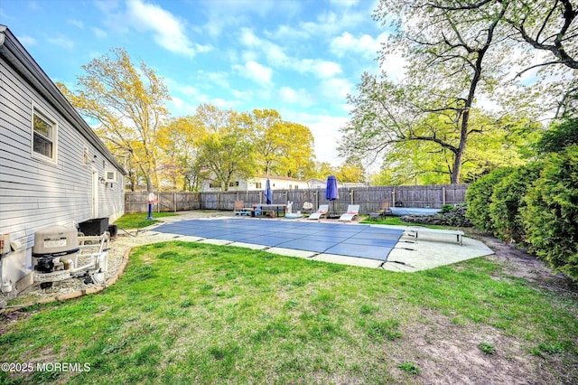 view of pool featuring a lawn, a fenced backyard, and a patio area