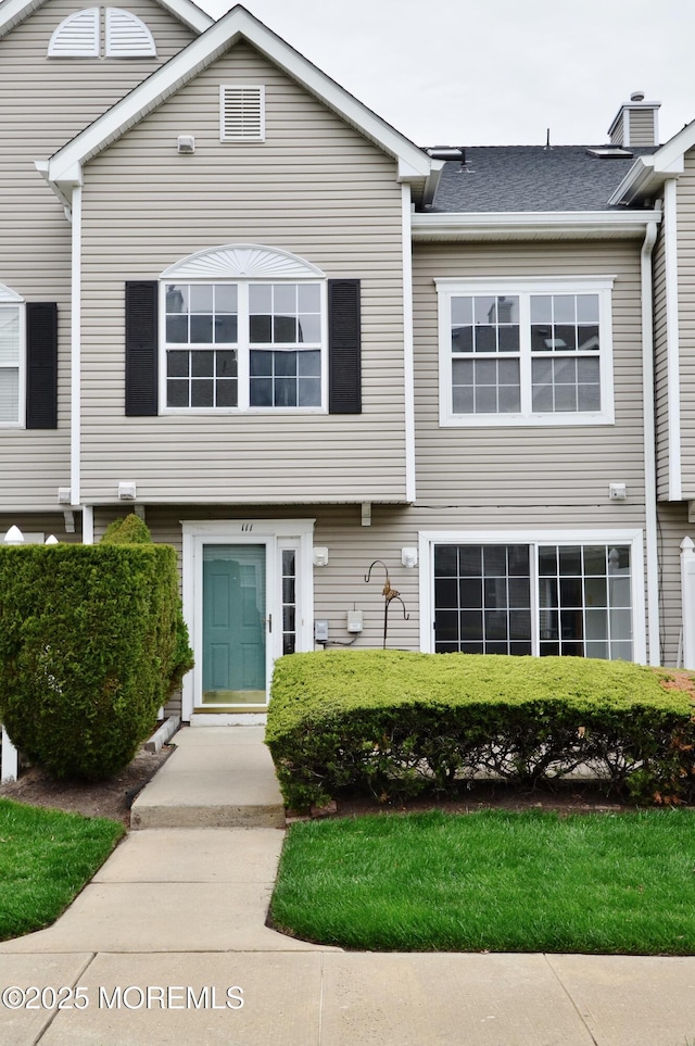 111 Watson Ct, Howell, NJ 07731 - view of front facade featuring roof with shingles and a chimney