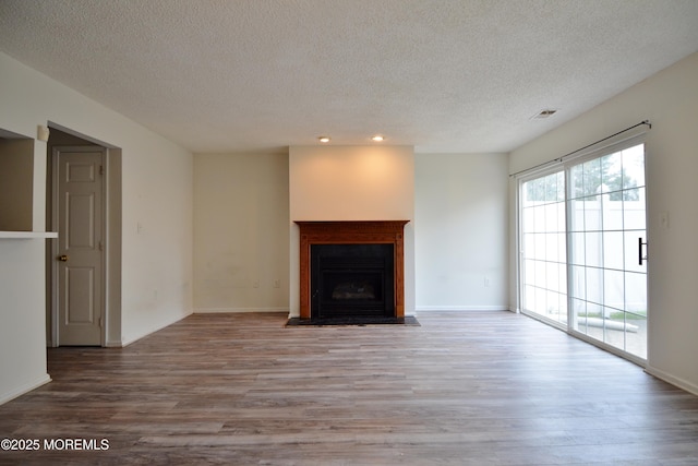111 Watson Ct, Howell, NJ 07731 - unfurnished living room with visible vents, a textured ceiling, wood finished floors, and a fireplace
