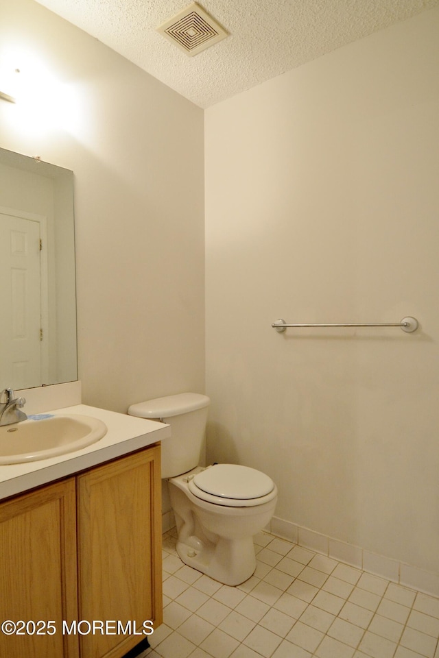 111 Watson Ct, Howell, NJ 07731 - half bathroom featuring tile patterned flooring, visible vents, vanity, toilet, and a textured ceiling