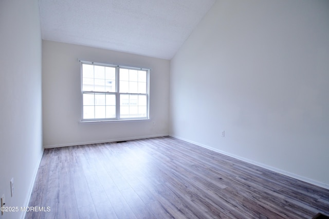 111 Watson Ct, Howell, NJ 07731 - unfurnished room with baseboards, lofted ceiling, and wood finished floors