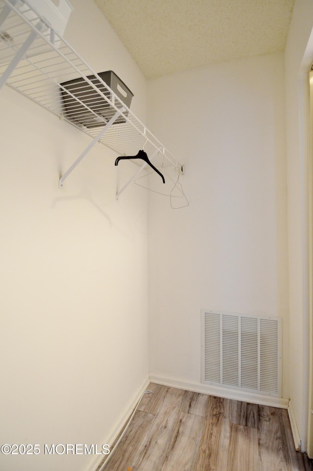 111 Watson Ct, Howell, NJ 07731 - walk in closet with visible vents and light wood-type flooring