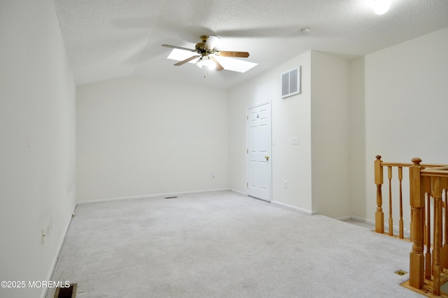 111 Watson Ct, Howell, NJ 07731 - carpeted spare room featuring ceiling fan, vaulted ceiling with skylight, a textured ceiling, baseboards, and visible vents