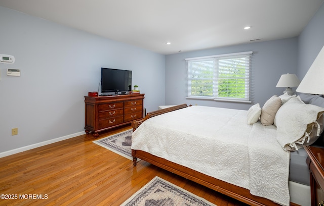 bedroom with light wood-style flooring, baseboards, and recessed lighting