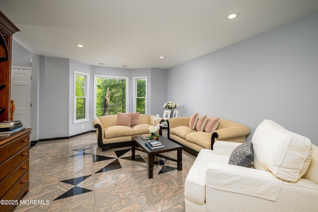 living area featuring recessed lighting and baseboards