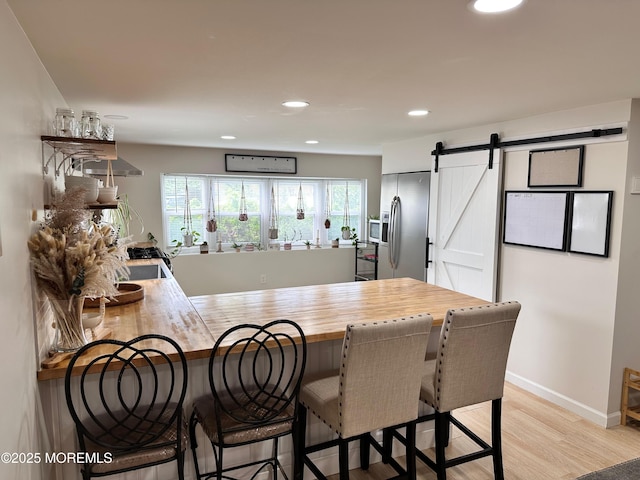 7 Misty Ln, Jackson, NJ 08527 - kitchen featuring a peninsula, butcher block countertops, stainless steel refrigerator with ice dispenser, a barn door, and light wood finished floors