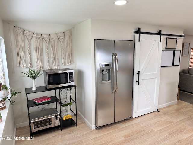 7 Misty Ln, Jackson, NJ 08527 - kitchen with light wood-type flooring, a barn door, baseboards, and appliances with stainless steel finishes