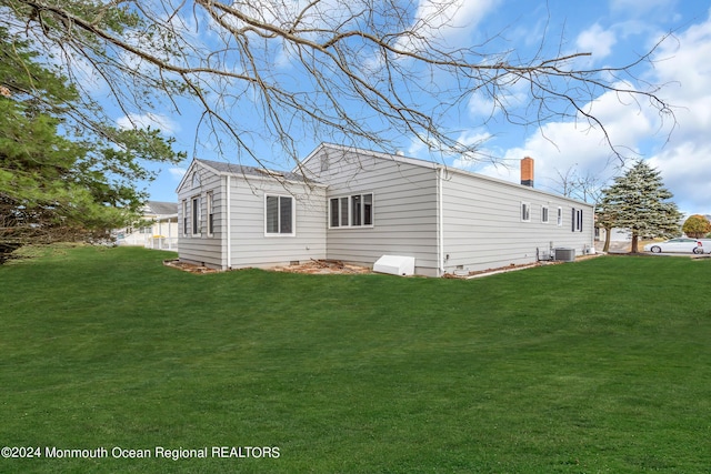 8 Venezia St, Toms River, NJ 08757 - rear view of house with a lawn, central air condition unit, and a chimney