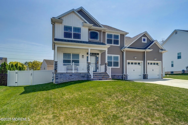 craftsman-style house featuring board and batten siding, concrete driveway, a gate, and a porch