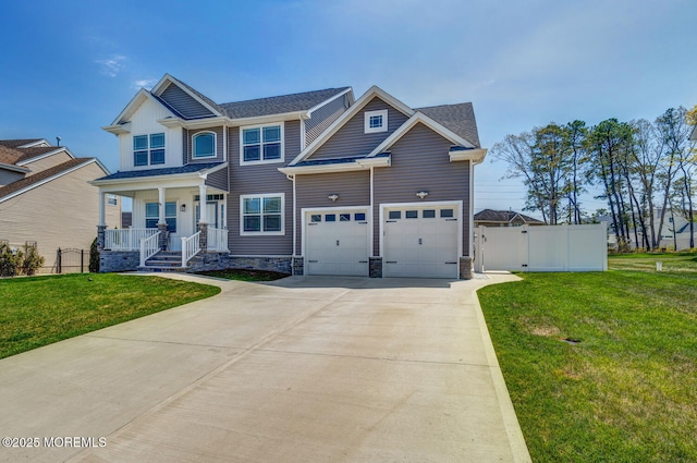 craftsman-style home with covered porch, fence, driveway, and a front yard