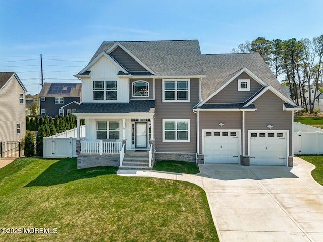 view of front of home featuring a front lawn, fence, covered porch, a gate, and concrete driveway