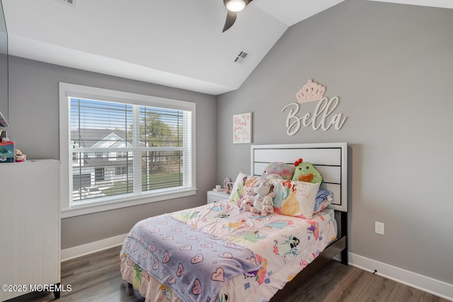 bedroom featuring visible vents, baseboards, wood finished floors, and vaulted ceiling