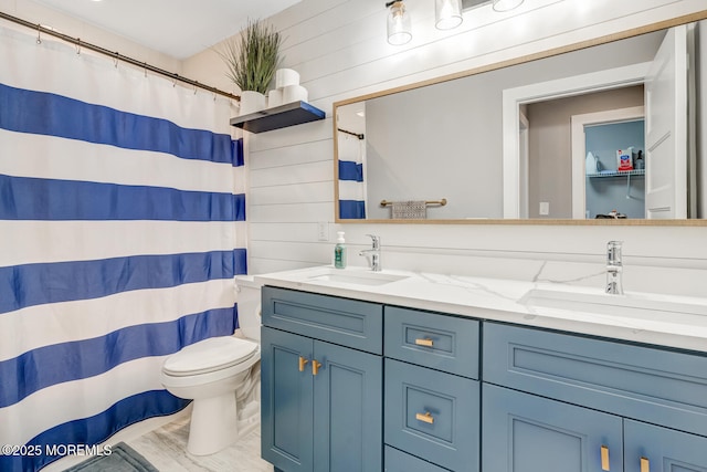 bathroom with double vanity, a sink, toilet, and a shower with curtain
