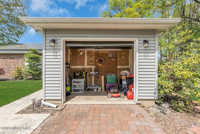 view of outdoor structure with driveway and a garage
