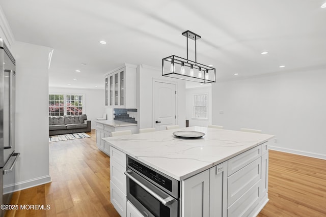196 Highwood Rd, Oakhurst, NJ 07755 - kitchen featuring white cabinetry, glass insert cabinets, stainless steel oven, recessed lighting, and light wood-style flooring