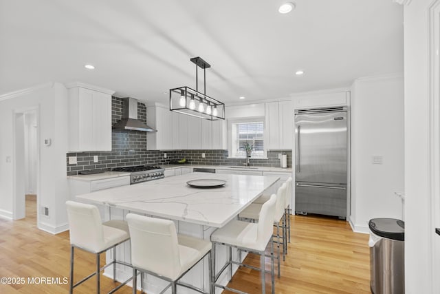 196 Highwood Rd, Oakhurst, NJ 07755 - kitchen featuring wall chimney exhaust hood, a center island, baseboards, decorative backsplash, and built in refrigerator