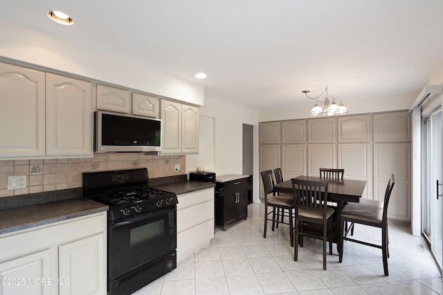 443 Lafayette Dr, Brick, NJ 08723 - kitchen featuring black gas range, stainless steel microwave, dark countertops, a chandelier, and backsplash