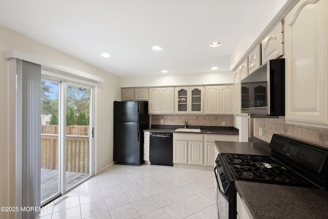 443 Lafayette Dr, Brick, NJ 08723 - kitchen with black appliances, dark countertops, a sink, decorative backsplash, and glass insert cabinets